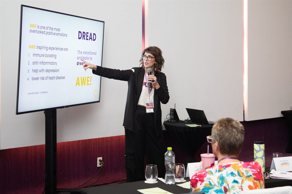 Lesley Bodine speaking at a leadership summit, presenting to an audience